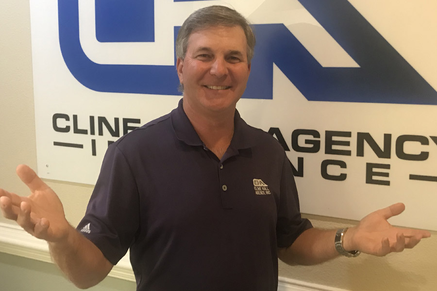 About Our Agency - Agency Owner in Front of Agency Sign About Our Agency - Agency Owner in Front of Agency Sign